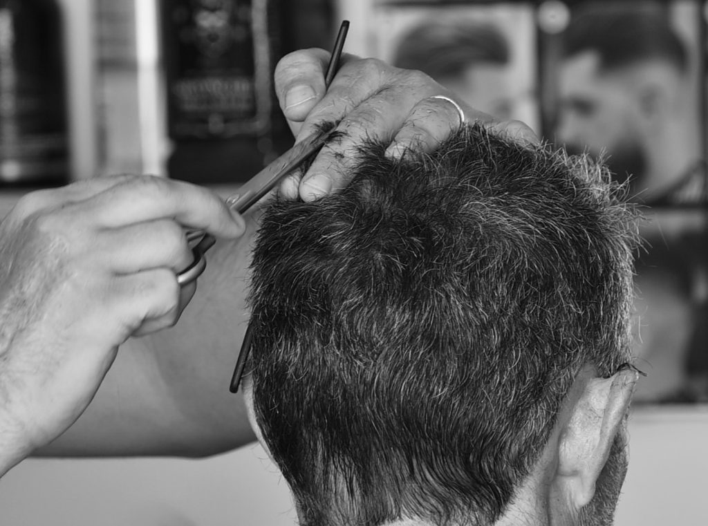 Close up of man cutting hair