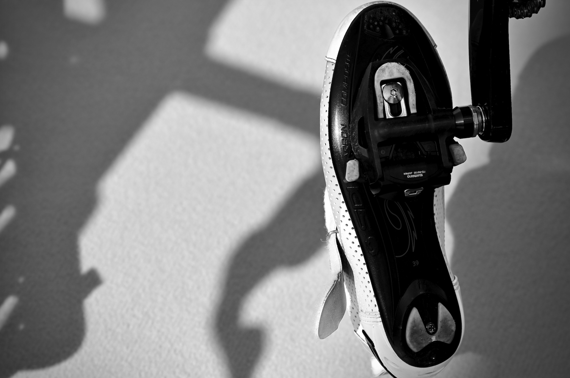 The underside of a bicycle shot clipped to a pedal