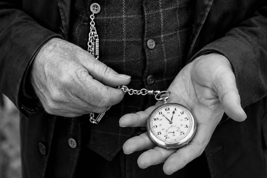 Close up of man holding a pocket watch