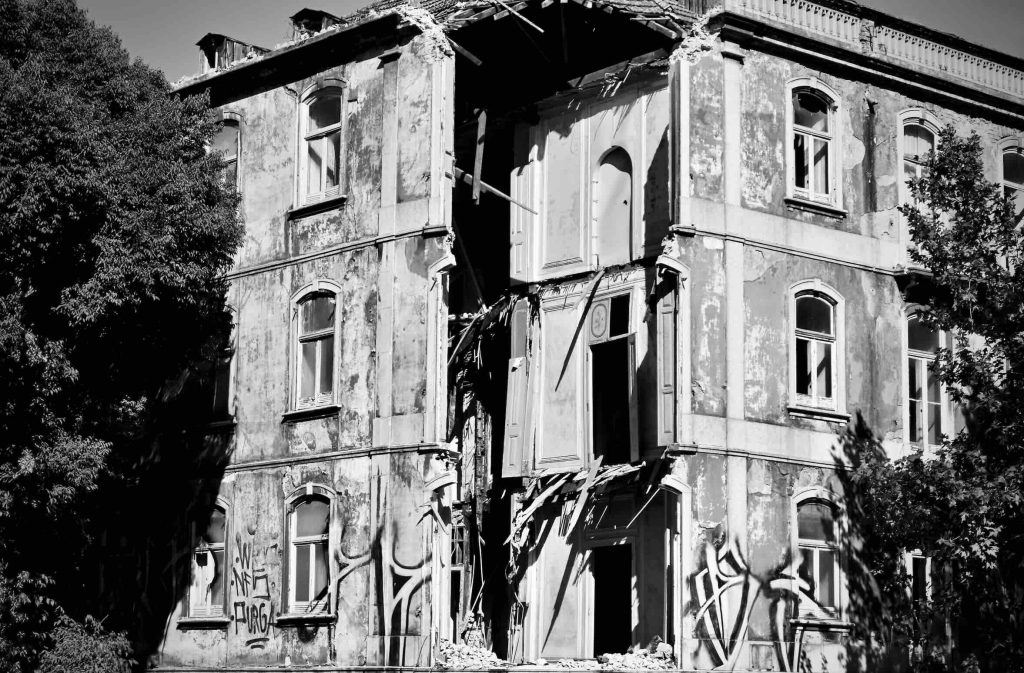 A derelict building with the corner fallen down