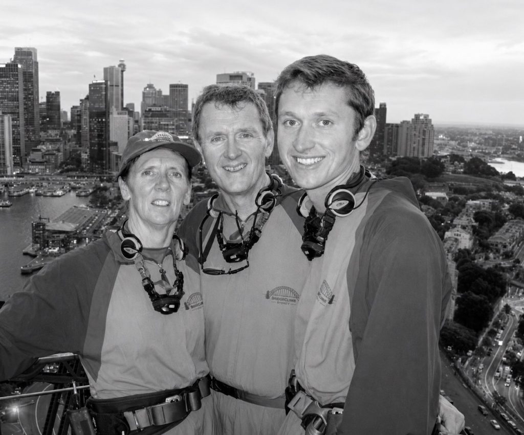 A woman and two men high above Sydney