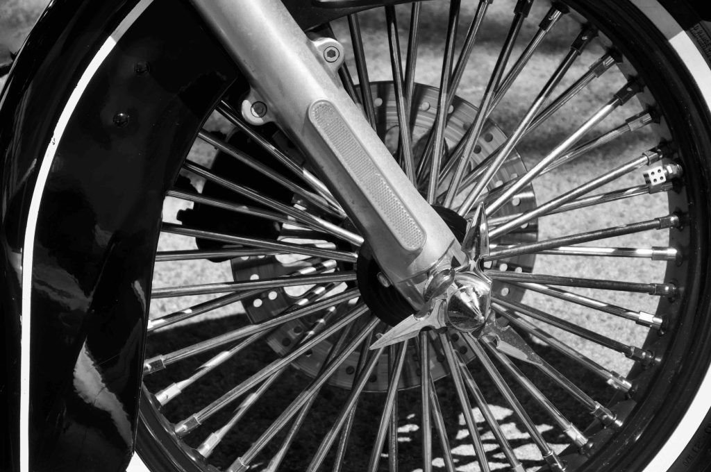 Close up of a Harley Davidson motorbike spoked front wheel